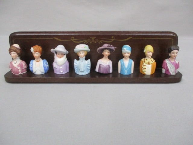 8 Vintage Avon Lady Thimbles on Wooden Shelf: .