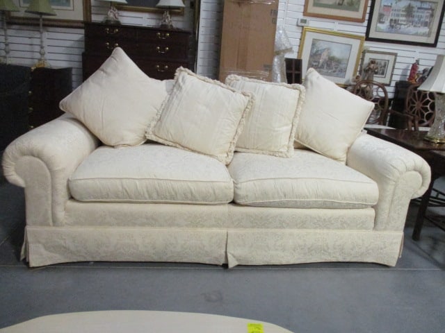 Ivory Demask Upholstered Rolled Arm Sofa with Pillows: 88" long, seat cushions and throw pillows are feather filled, small tear on back top edge, left arm and kick pleat need to be spot cleaned from moving, Local Pickup Only