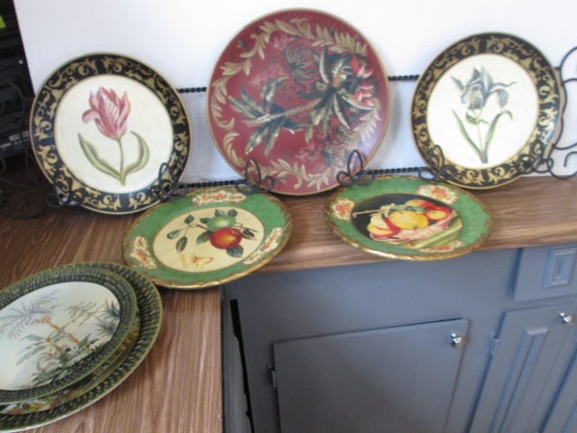 Seven Handpainted Decorative Plates and Metal 3 Plate Rack: Rack is 46" long, see pictures for plate designs, some are Raymond Waites, Local Pickup Only
