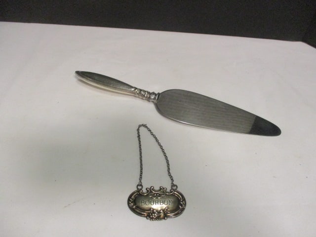 Sterling Silver "Bourbon" Bottle Tag and Sterling Silver Handle Stainless Blade Cake Server and: Tag weighs 0.27 ozt.