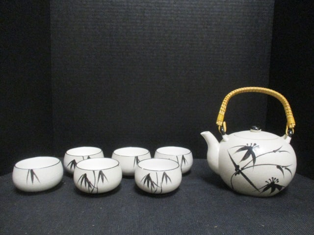 5 Piece Chinese Pottery Tea Set with Bamboo Leaf Motif: (4)2 1/4"h cups, teapot 4 3/4"h(8"h with woven handle up), textured glaze finish