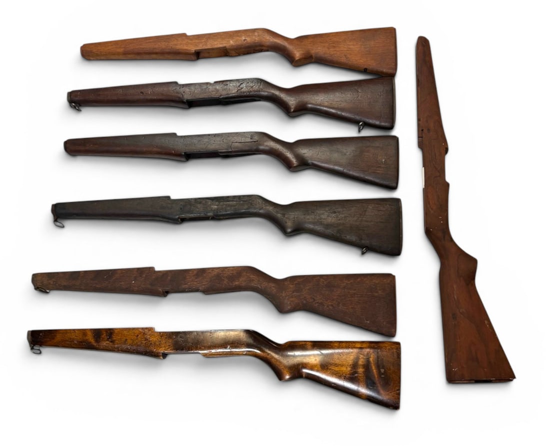 (7) M1 Garand “Repair Special” Battle Rifle Stock Project Lot: Two of the stocks appear to be new post-war production. Three have cracks on the rear receiver side. One has been repaired. One has had the buttplate end shaved but has remarkable looking wood grain. 