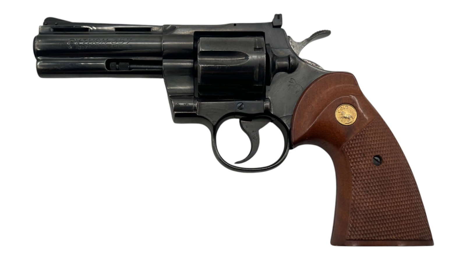 1975 Colt Python 4" Blued .357 MAGNUM Revolver: S#: 14946E, mfg. 1975 | 4" Barrel | 6-shot SA/DA |||| CONDITION: Very good. 85% original blued finish, with some finish loss and signs of surface scratches. Grips are good condition with edge wear and