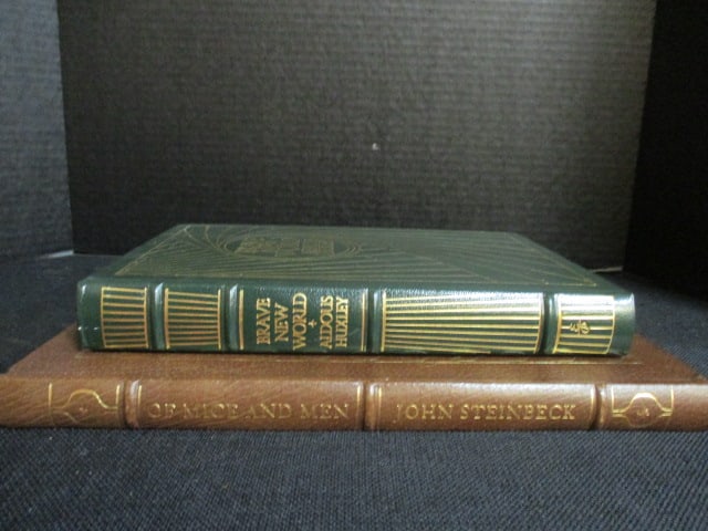 Two Eastman Press Leather Bound Classic Works of Literature: "Brave New World" by Aldous Huxley and "Of Mice and Men" by John Steinbeck. Books copyrights range from 1960-80's