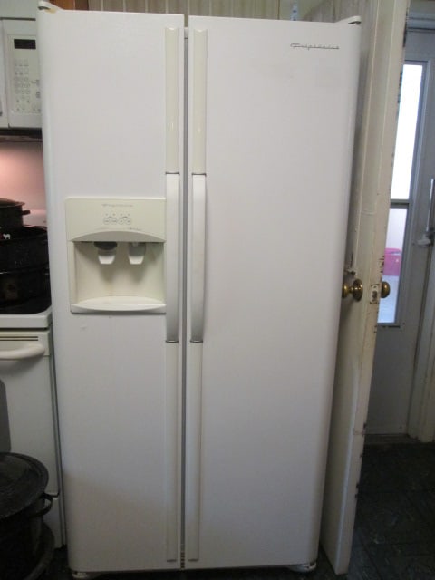 Frigidaire White Side x Side Refrigerator with Ice/Water in Door: 32 5/8" x 31 3/4"(without handles) x 69 1/4"(including hinges), Model FRS23LS5DW3, Serial #LA43523030, DOM 09-04, Works good, has owner's manual, needs normal cleaning from spills, Bring Tools and Add