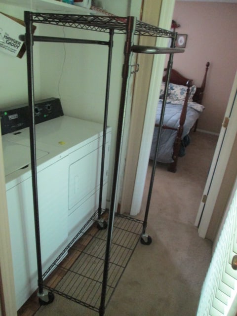 Portable Black Wire Hanging Rod Utility Cart: 35" x 24" x 66 1/2", locking wheels, upper shelf and lower shelf, two hanging rods and two swing out hanging rods, Local Pickup Only