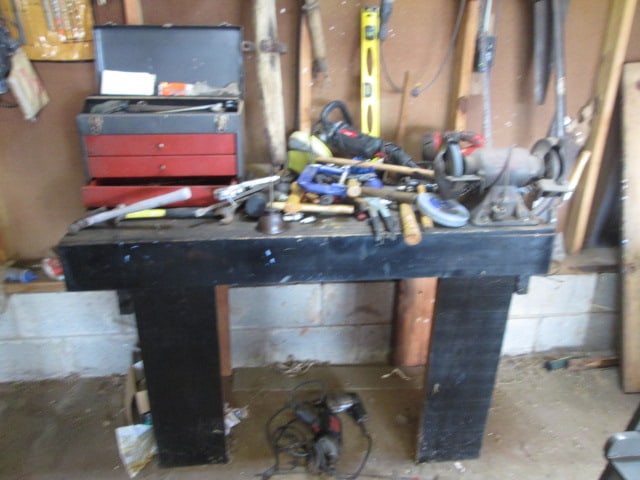 Contents of Garage Back Wall-Workbench with Grinder, Metal Tool Box, Hand Tools, etc.: See all pictures and preview, Take what you want, Yellow Reel Worklight is Not Included. Local Pickup Only