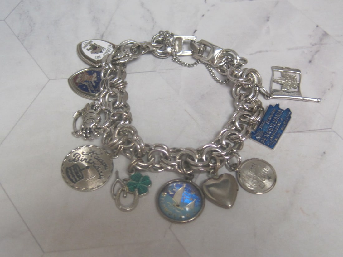 Vintage Monet Silvertone Charm Bracelet with 10 Sterling Silver Charms: .