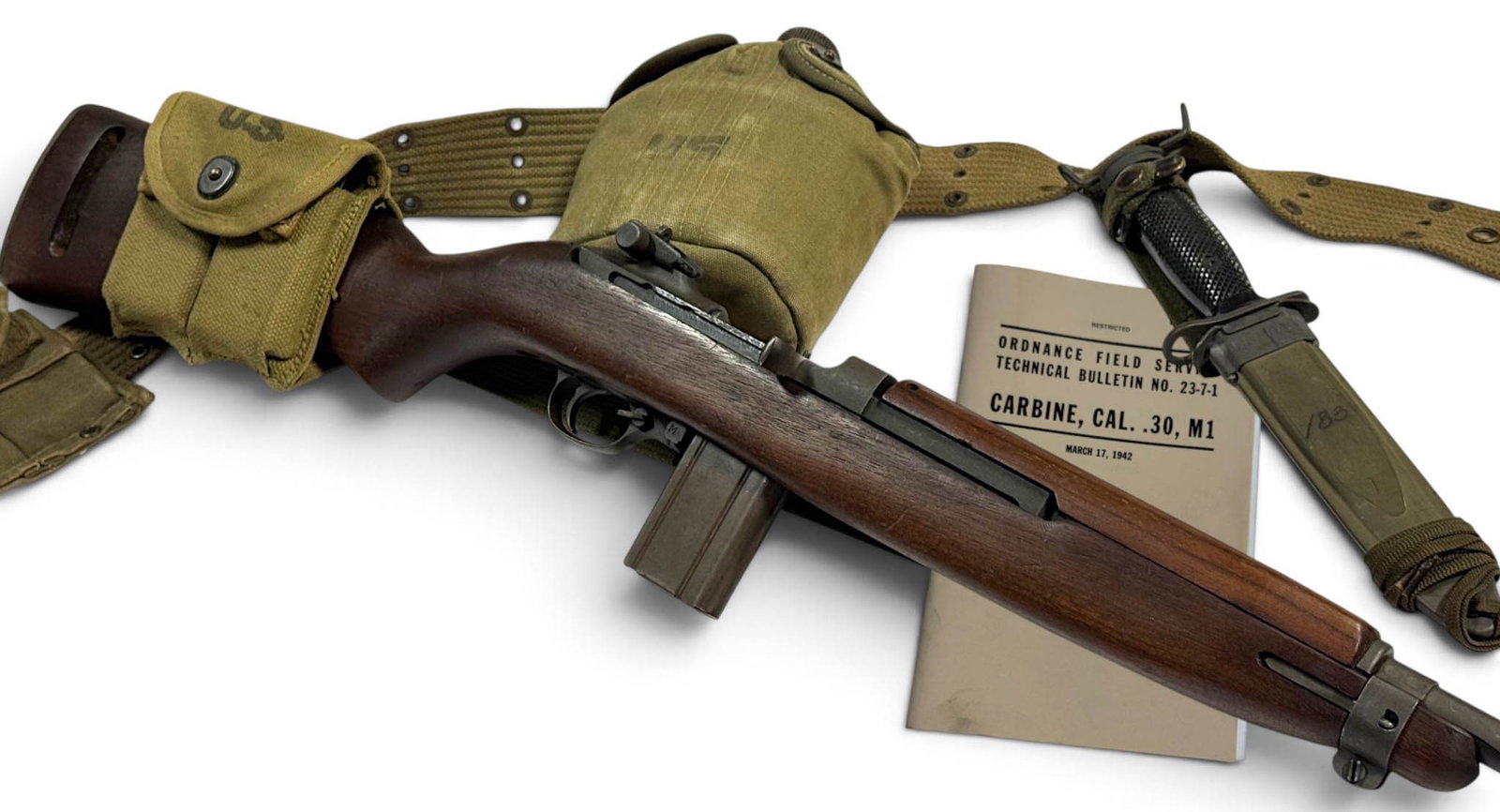 Excellent WWII 1943 Inland Div. M1 Carbine .30 CAL. Semi-Automatic Rifle with Manual & Rig: S#: 324992 | 18” Barrel marked by Inland Div. and dated 1943 | No import marks | Original Canvas Sling & Oil Bottle | Comes with a nice Magazine Pouch dated 1943 | Low Wood Stock stamped