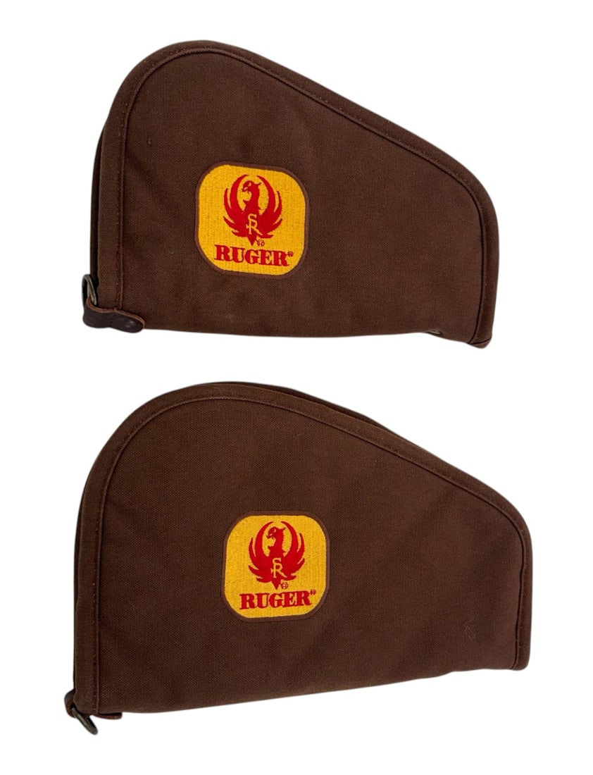 (2) Rare Vintage Sturm 10” & 12” Ruger Soft Pistol Rug Cases: These two cases, brown exterior with the red and yellow Ruger label feature a nice red fabric interior. One case is 10” and the other is 12”. Both in excellent, like new condition.