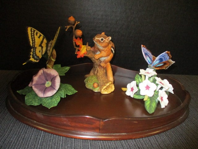 Froelich Furniture Mahogany Display and Three Lenox Fine Porcelain Figurines: Display 12" x 7 7/8" x 1 1/2", Figurines include 1991 Autumn Adventure "Eastern Chipmunk"(5"h), 1989 "Swallowtail"(4 1/2"h-has been repaired), 1989 "Blue Temora"(3 1/2"h)