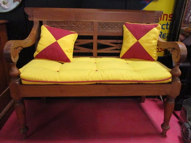 Vintage Eastlake Style Carved Wood Child's Settee with Scroll Arms and Floral Carvings: 30 1/2" long, wood slat seat has removeable cushion and two accents pillows, turned legs and geometric back with carved florals, seat cushion has some spots, Local Pickup Only