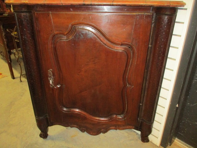 Antique French Provincial Style Corner Petite Armoire Single Door Cabinet: Shaped Raised Panel Locking Door with Key, Curved Apron, Rounded Front Corners and Carved Cabriole Feet. Wood Top Is Painted Marble Faux Finish. Rounded Corners Have Carved Diamond Dot Pattern. 29