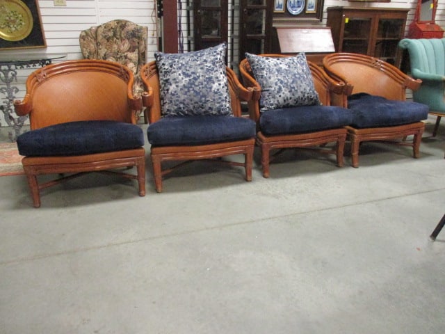 Four British Colonial Style Rattan and Cane Barrel Back Armchairs with Removable Seat Cushions: 31"w, cushions have navy blue upholstered zip on covers over original black leather seat cushions, includes two throw pillows, slip covers needs some slight spot cleaning, Local Pickup Only
