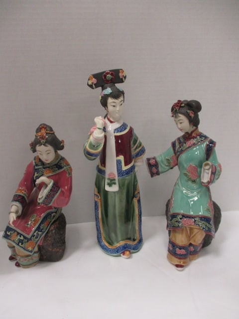 Three Chinese Shiwan Wucai Style Porcelain Geisha Figures: 9 1/2"h(chipped fingers), 10 1/2"(both hands broken off, bottom of one earring broken and chipped dress), 12 1/2"h(bottom of one earring broken)
