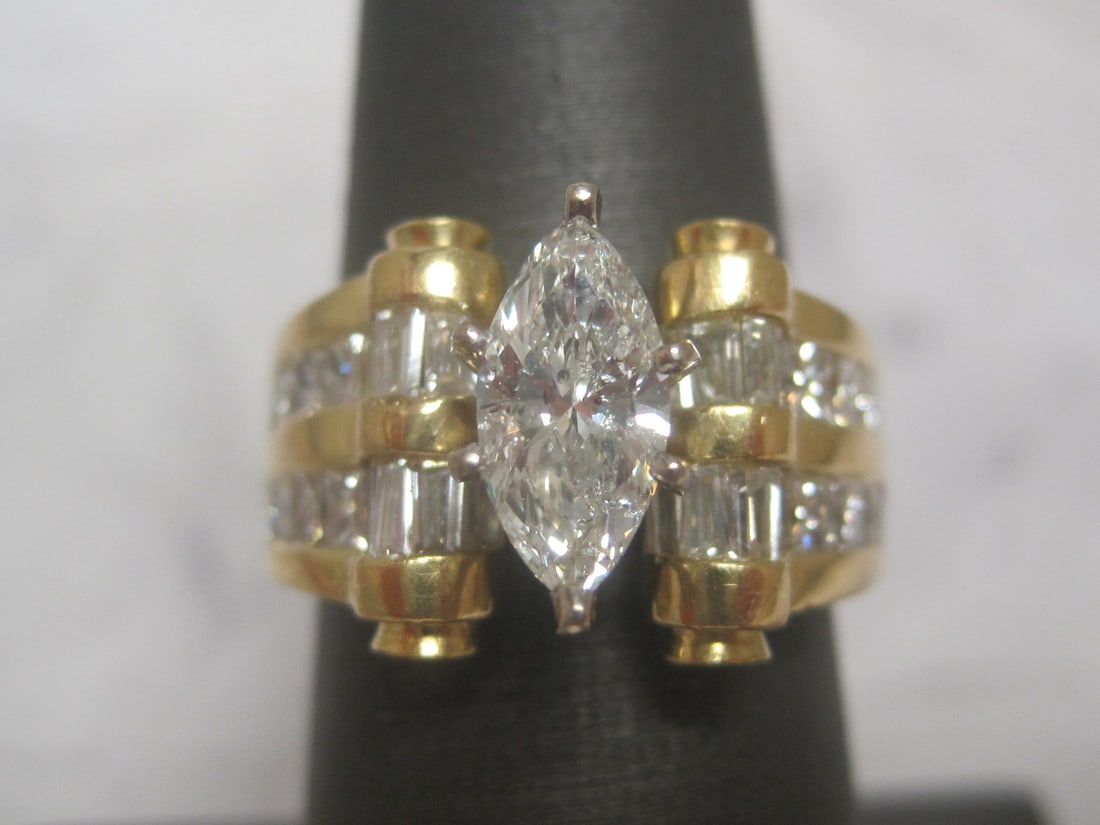 18k Yellow Gold & 14k White Gold Marquise 3.12 CT TW. Diamond Ring appraised at $16,500: 18k yellow gold & 14k white gold diamond ring featuring a 0.82 carat natural marquise brilliant center cut diamond (I/SI-2) accented by 36 natural baguette, princess, & round brilliant cut diamonds