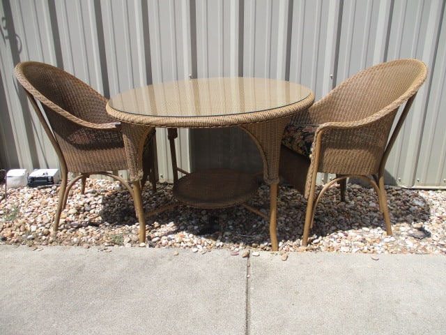 Lloyd Loom Woven Resing Indoor/Outdoor Round Table and Pair of Barrel Back Arm Chairs: Chairs have removable cushions, Table 42"dia x 30"h, chairs 23"w, cushions have some UV light fading, table has glass top protector, Local Pickup Only