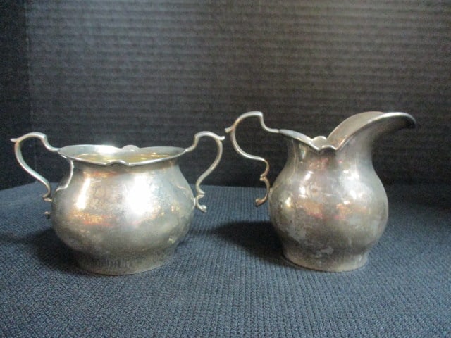 Sterling Silver Creamer and Open Sugar Bowl: 5.88 troy ounces total, 3"h(top of handle) sugar bowl, 3 1/2"h creamer