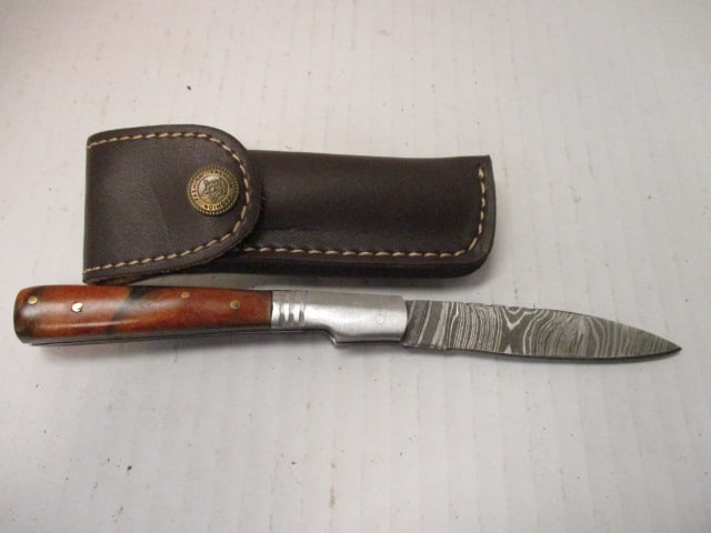 Damascus Steel Folding Blade with Resin Handle: No rust noted.