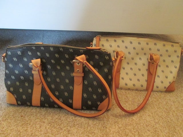 Two Dooney & Bourke Monogram Satchel Purses: Black purse includes eye glass case and credit card wallet, Cream purse includes wristlet, one leather clip-on shoulder strap for both purses, purses unauthenticated see pictures and preview to make o