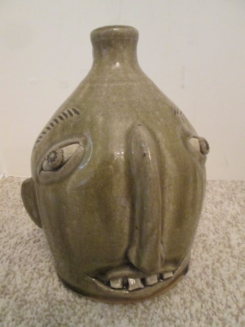 Otis Norris, Crystal Sullivan Signed Southern Folk Art Wind Spirit Face Jug: 8 1/2"h , incised maker's mark on bottom Otis Norris Crystal Sullivan and in grease marker 1st wood firing, has chip on bottom edge