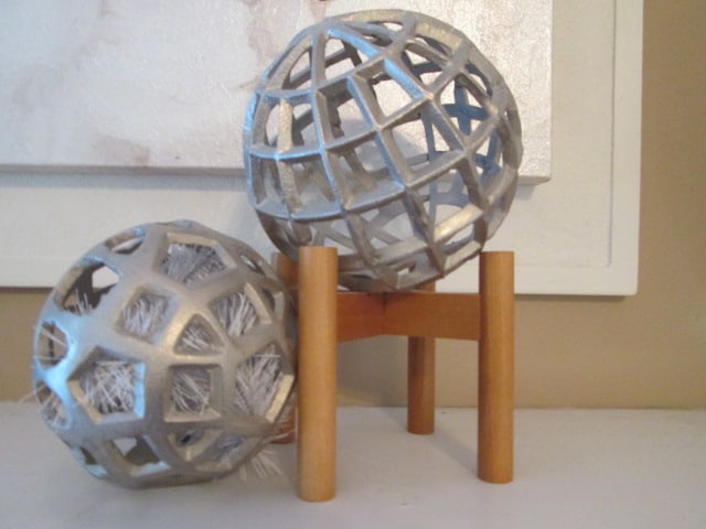 Two Geometric Cast Metal Orbs Home Accents: One on wood stand 11"h, other has white bristle LED lights on inside-6"dia, battery operated lights works