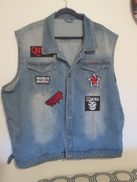 Denim Vest with Rock Artist Patches: Vest appears to be X-large to XX-large in size, patches include Queen, Marilyn Manson, Cannibal Corpe, Misfits and Punk/Heavy Metal Hand Making Horn Gesture