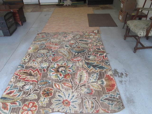 Three Area Rugs: Rubber back mat 30 1/2" x 47 1/2", Earth tone indoor/outdoor 5' x 8', Floral cut pile bound area rug 5' x 7', Local Pickup Only