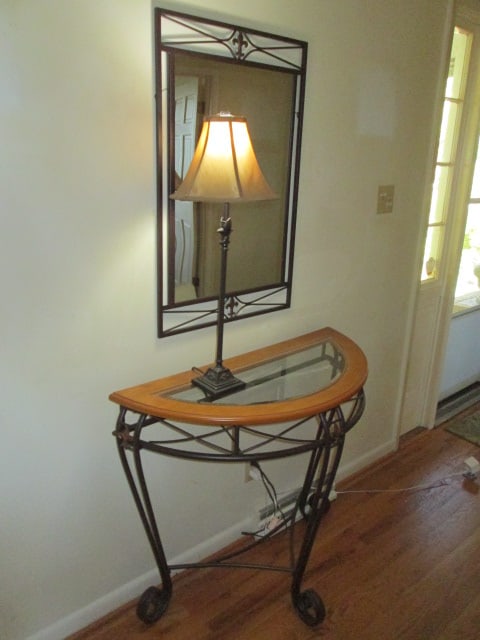 Bronzed Metal 3 Piece Wall Mirror, Demilune Table and Lamp with Fleur-de-Lis Motifs: Mirror 22" x 34 1/2", Demilune table 37 1/4" x 17" x 32 1/2", Lamp 29 1/2"h, table has beveled glass and wood top with scrolling metal base, Local Pickup Only