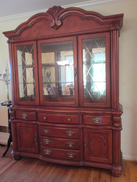 Broyhill 100th Anniversary Collection Serpentine 2 Piece Illuminated China Hutch: Illuminated Mirrored Back China Hutch with Two Glass Shelves. Glass Has Cut Diamond Pattern, Glass Sides and Single Beveled Glass Door. Base has three drawers over two doors and three drawers. Center