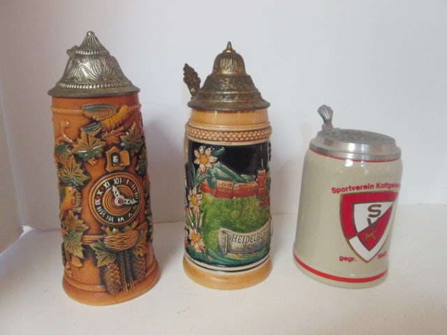 Three German Bas-Relief Stoneware Tankards: .