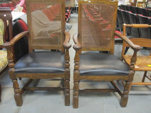 Pair of Davis Cabinet Co. Spanish Colonial Revival Tavern Style Wood Arm Chairs: with Black Vinyl Seats and Caned Backs. 24"w, Local Pickup Only