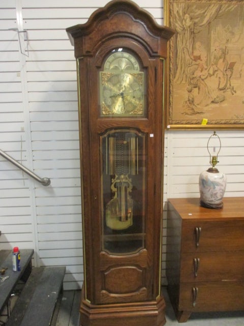 1982 Howard Miller "The President" Moon Dial Grandfather Floor Clock: Oak with Burlwood Veneer Accents, Model No. 610-156, Serial No. 301631, Has key and owner's manual, case locks but does not have key, West German movement, has key winds, keeps time and chimes, has