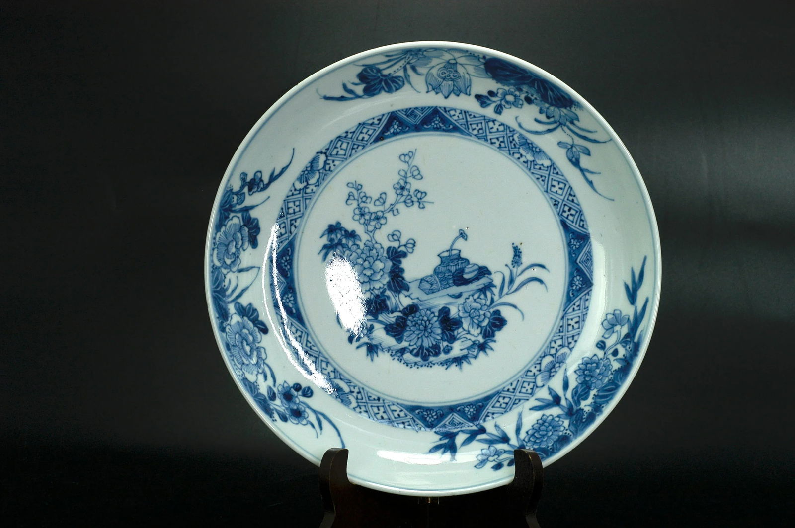 Qing Dynasty Blue and White Floral Plate: Dimensions H: 4.3cm W: 25.5cm - Qing Yongzheng Blue and White Scholar's Offering Floral Plate. Period: Qing Yongzheng (18th century). Material: Jingdezhen porcelain with white glaze ground and blue an
