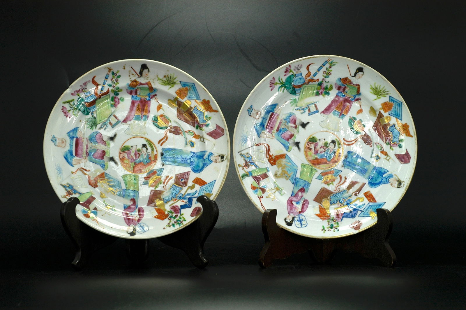Qing Dynasty Famille Rose Figures Antique Objects Plate, a Pair: H2.6cm x W20.1cm. Qing Dynasty Tongzhi-Guangxu Famille Rose Gilt 'Four Arts' (Qin Chess Calligraphy Painting) and Precious Objects Dishes (Pair, Export Ware). Dating: Authentic late Qing period (Tongz