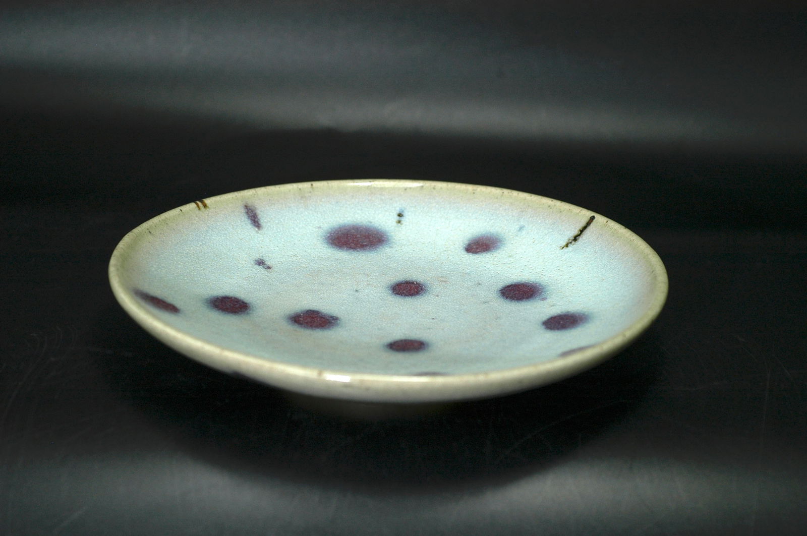 Yuan-Ming Dynasty Jun Ware Sky-Blue Glaze Red Splash Dish: H3.2 cm x W19 cm Jun Ware Sky Blue Glazed Red Splashed Dish ('Stars in the Sky'). Core material: Jun ware porcelain with sky blue glaze and kiln-transmuted red splashes. Estimated period: Yuan Dynasty
