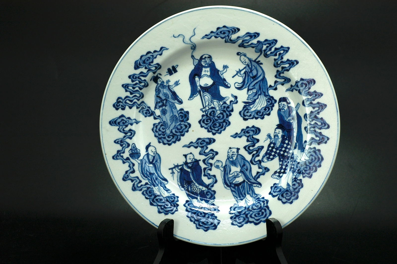 Qing Dynasty Blue and White Eight Immortals Cloud Crane Foliated Rimmed Dish with Xuande Mark: H2.3cm W23.7cm Object identification: Qing Kangxi Blue and White Eight Immortals and Cranes Folded Rim Dish (imitating Xuande mark). Period conclusion: Authentic Qing Kangxi period piece, fine folk ki
