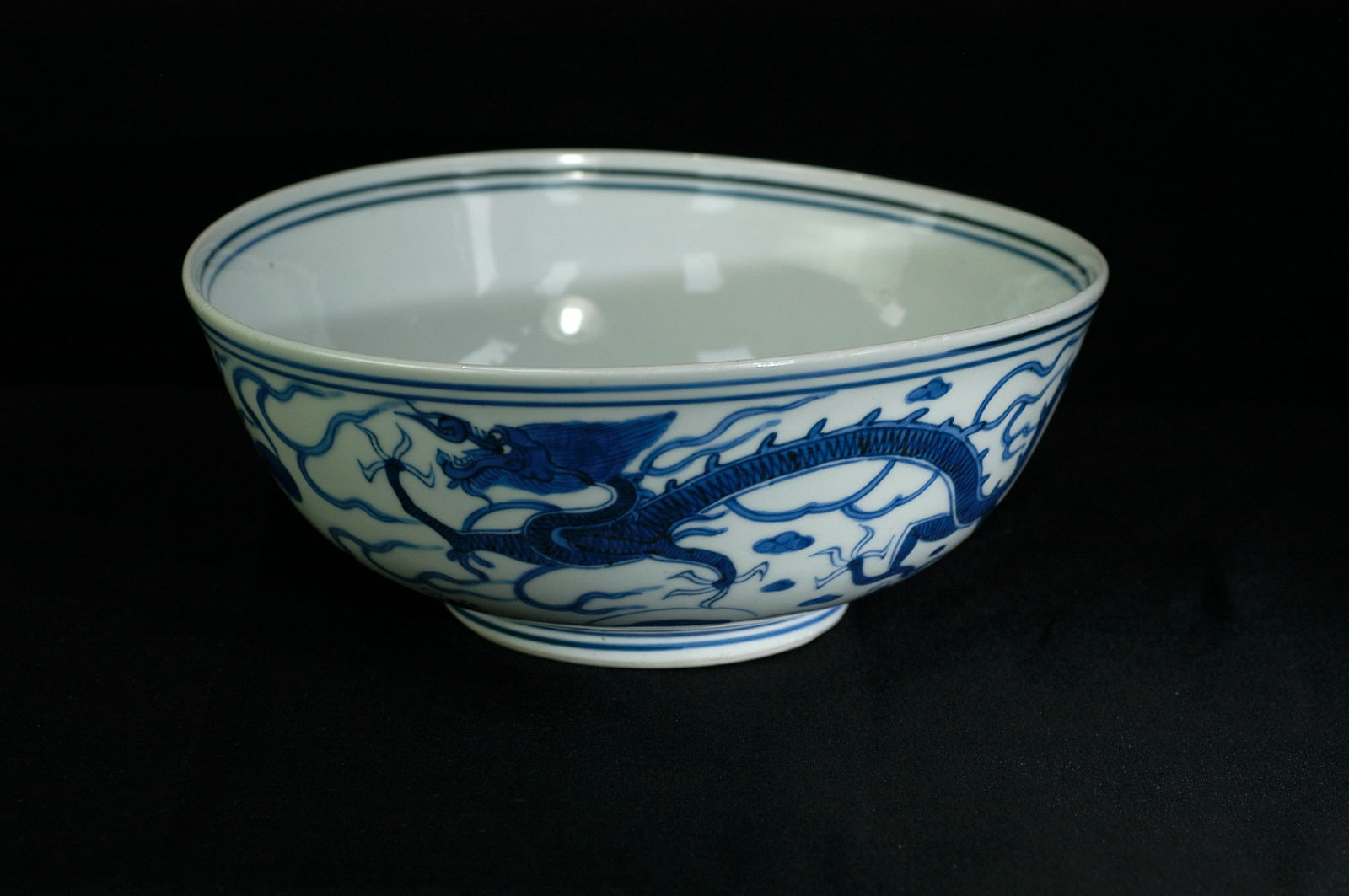 Ming Dynasty Blue and White Dragon and Phoenix Bowl with Xuande Mark: H8.2cm x W21cm. Blue and white bowl with dragon and phoenix design bearing 'Da Ming Xuande Nian Zhi' mark. White porcelain body with blue and white. Qing Kangxi period (imitating Xuande imperial ware)