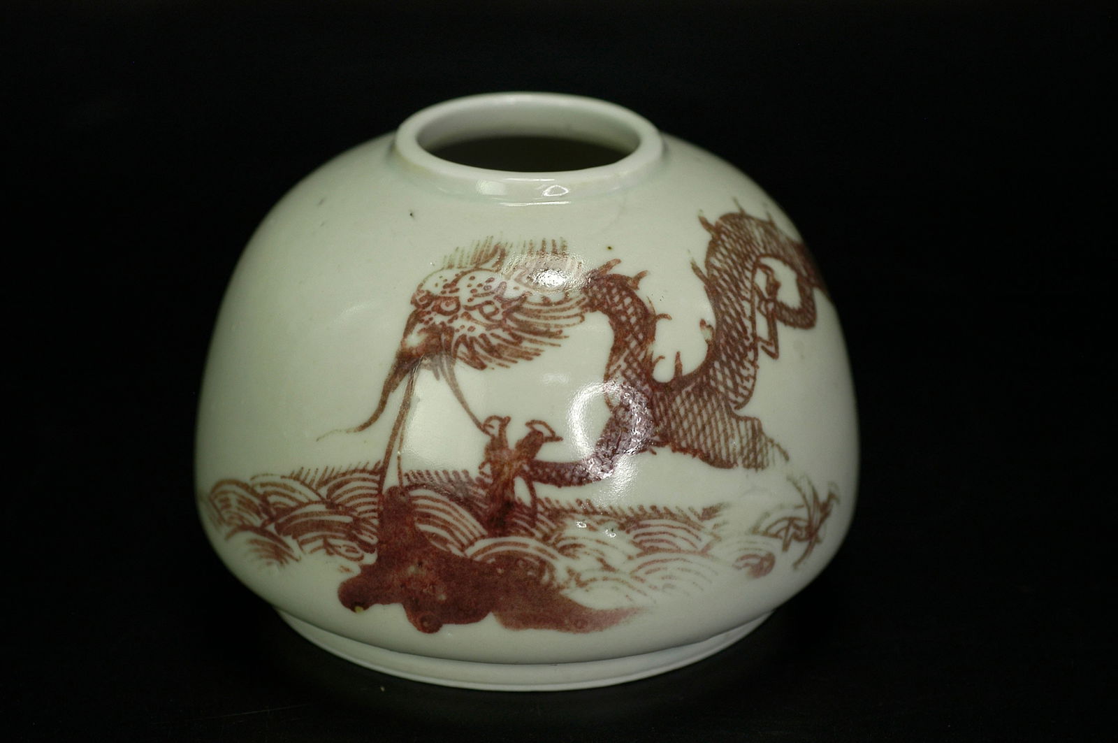 Qing Dynasty Underglaze Red Sea Dragon Water Pot with Kangxi Mark: H6.5cm x W8.7cm. Ming Dynasty Longquan Celadon Tripod Washer with Drumhead Studs (with carved rosewood cover). Core materials: Longquan celadon (celadon glaze), rosewood (zitan) openwork cover. Dating