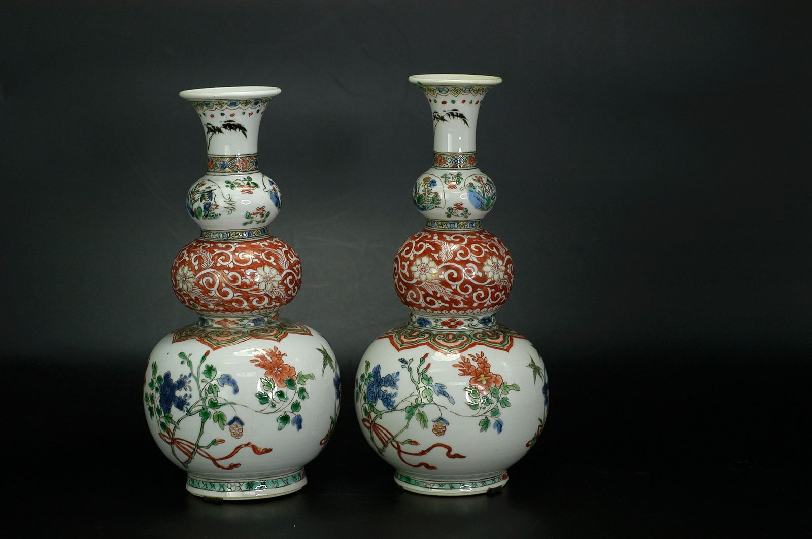 Qing Dynasty Wucai Floral Insect Gourd Vase, a Pair: Pair of Qing Kangxi Wucai Floral Triple Gourd Vases ①H:22.5cm W:9.6cm ②H:22cm W:9.8cm. Qing Kangxi period (17th-18th century). Jingdezhen kiln porcelain with white glaze ground and wucai d