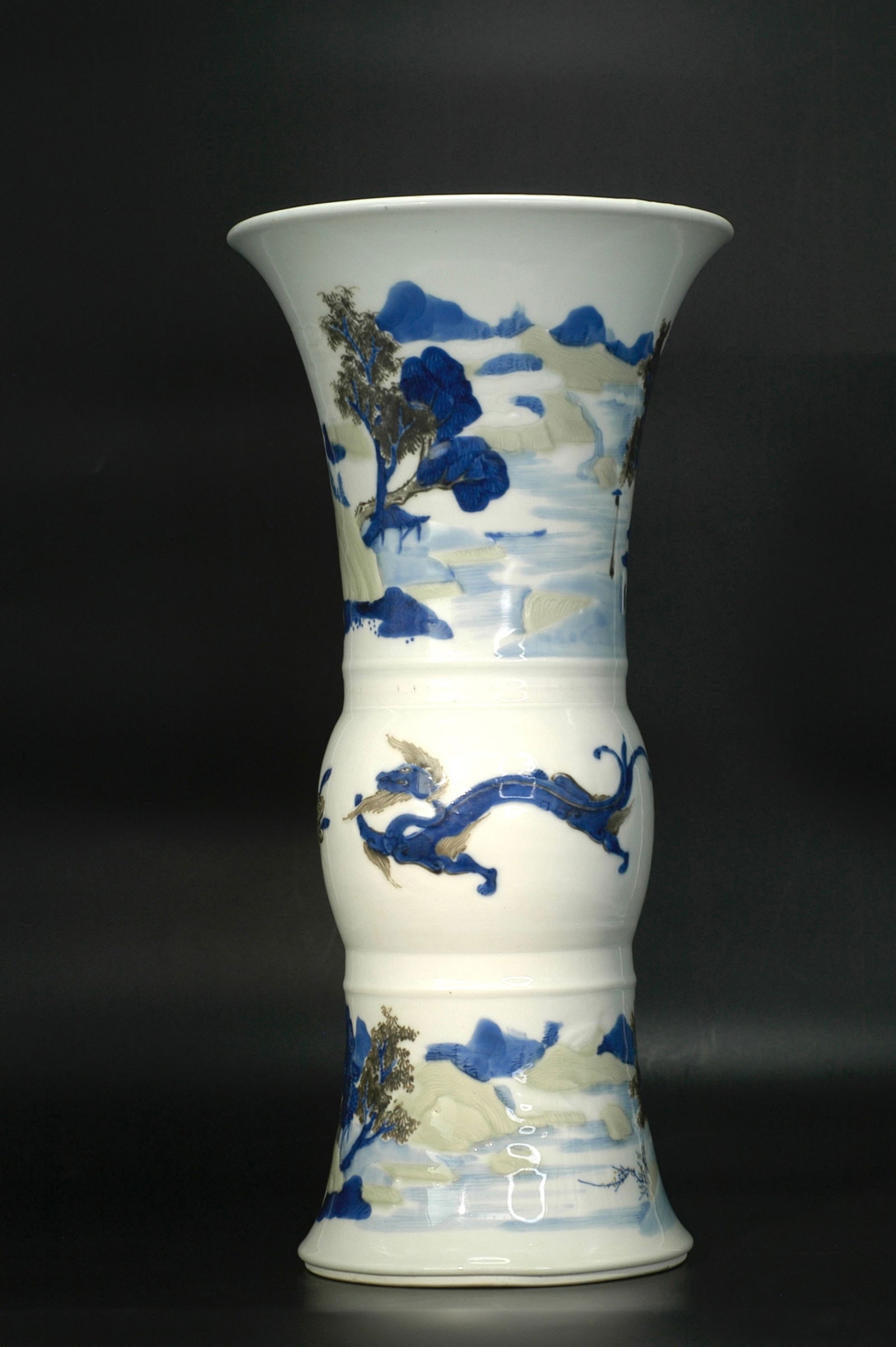 Qing Kangxi Low-Relief Underglaze Tricolor Dragon Landscape Vase with Kangxi Mark: H:40.2cm W:20cm. Qing Kangxi period (Imperial kiln). Standard gu-form vase (phoenix-tail vase). Underglaze tri-color technique (blue and white + copper red + celadon glaze). Base inscribed with six-ch