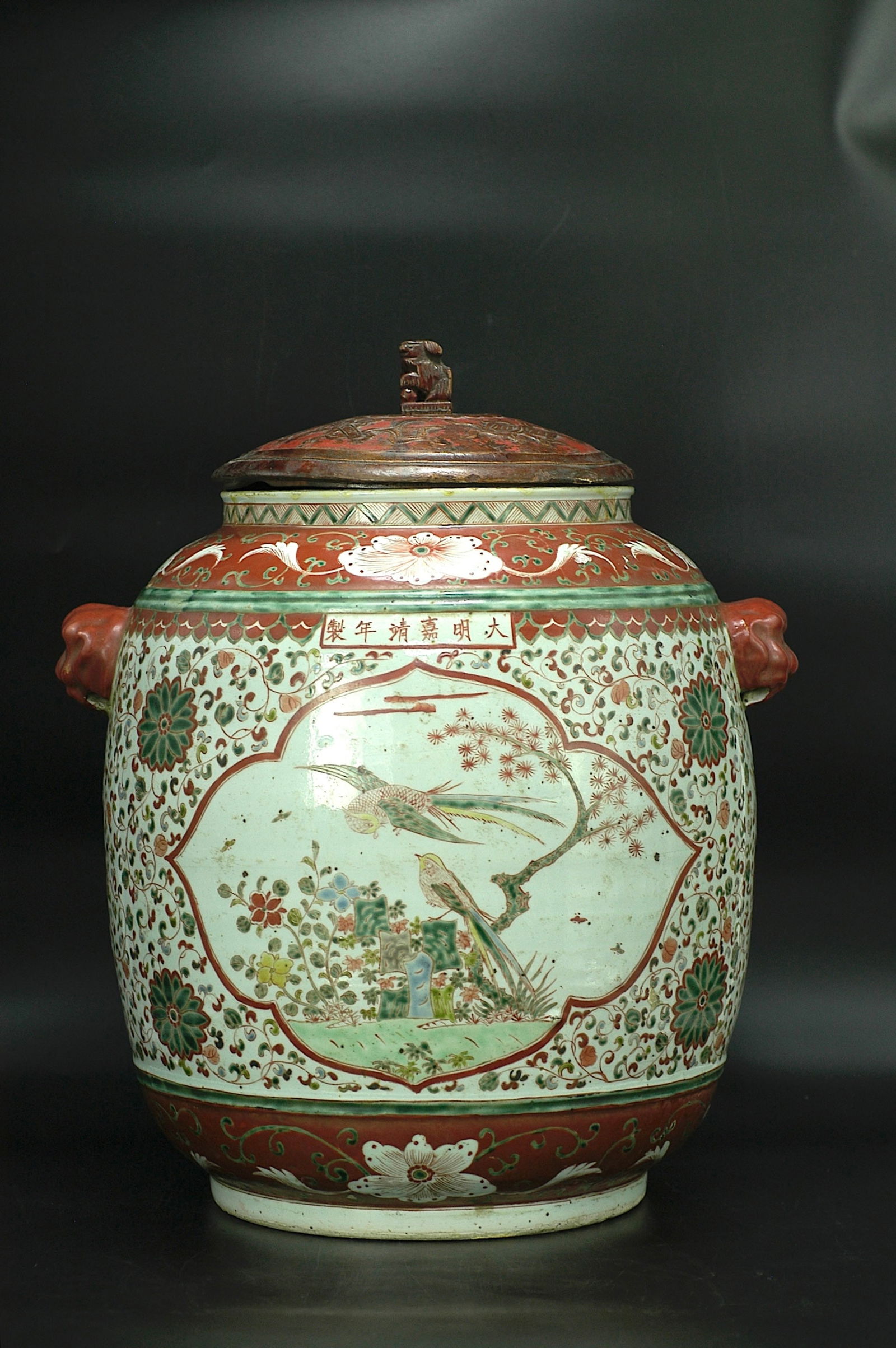Wucai Bird-and-Flower Beast-Handle Jar with Jiajing Mark: H37.5cm x W37cm. Wucai Floral and Bird Jar with Beast Handles (Marked Da Ming Jiajing Nian Zhi). White porcelain body with wucai decoration. Jiajing style (later reproduction/Republican period/late Qi