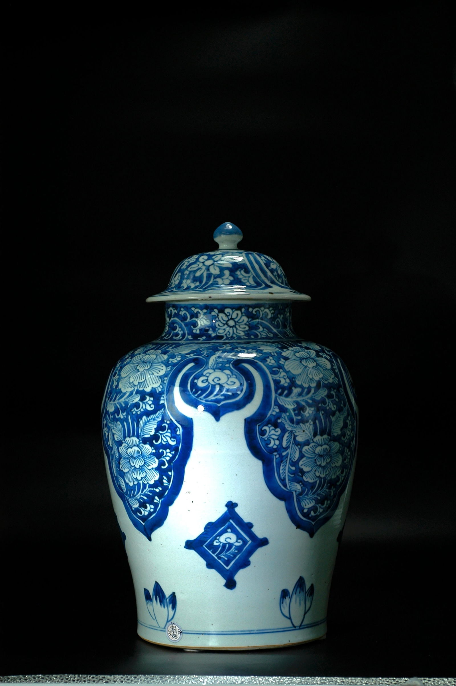 Qing Dynasty Blue and White Floral General Jar with Cover: H:40cm W:21cm. Period: Qing Kangxi period (fine folk kiln masterpiece with original cover). Subject: Blue ground with white reserve (reverse blue and white) technique, decorated with ruyi cloud should