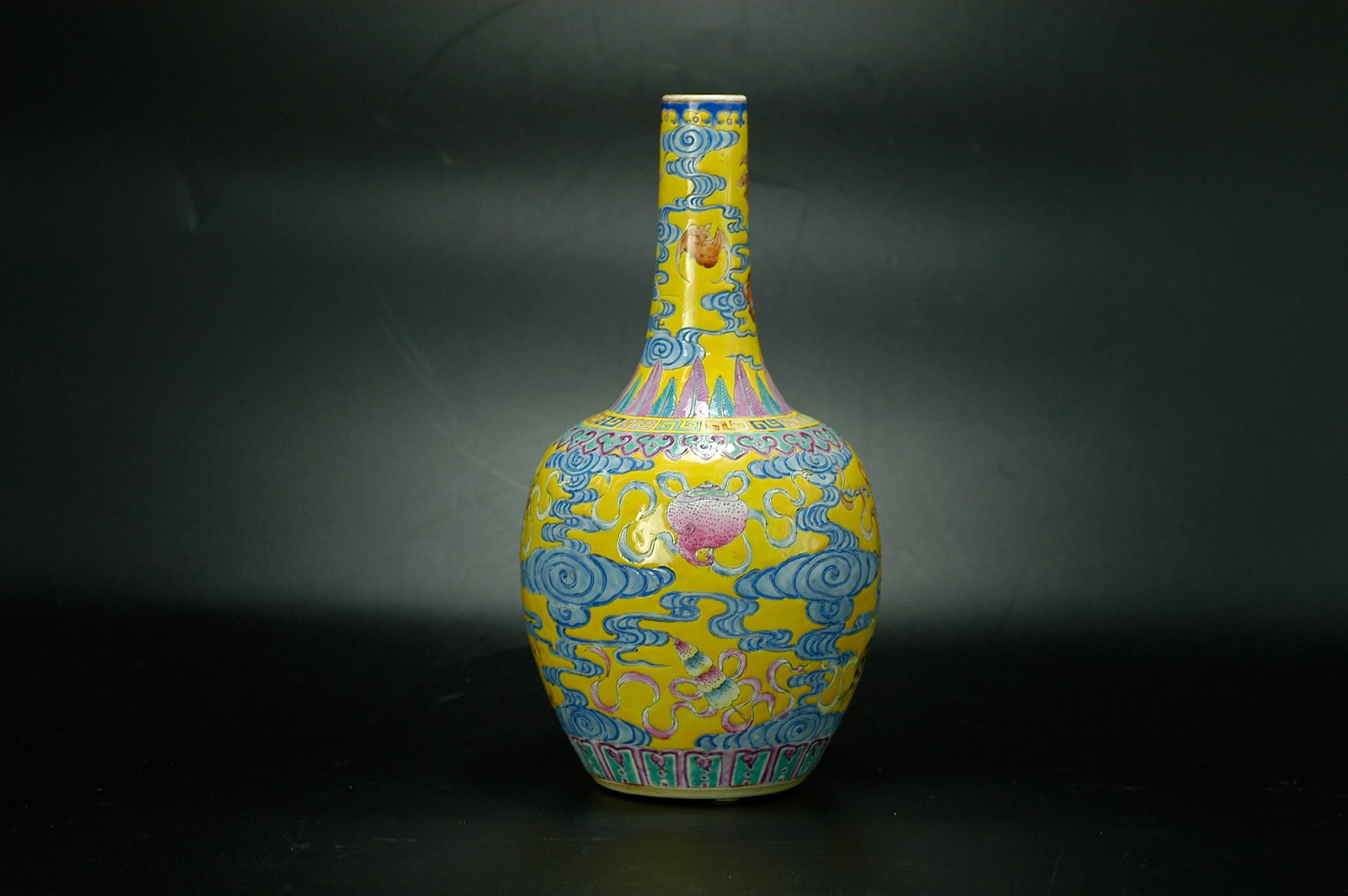 Qing Dynasty Yellow-Ground Famille Rose Eight Auspicious Symbols Five Blessings Vase with: H: 25CM W: 11.5CM Object designation: Qing Kangxi-Yongzheng yellow-ground famille rose Eight Auspicious Symbols bottle vase (tianqiu bottle form). Dating conclusion: Qing Dynasty Kangxi to Yongzheng p