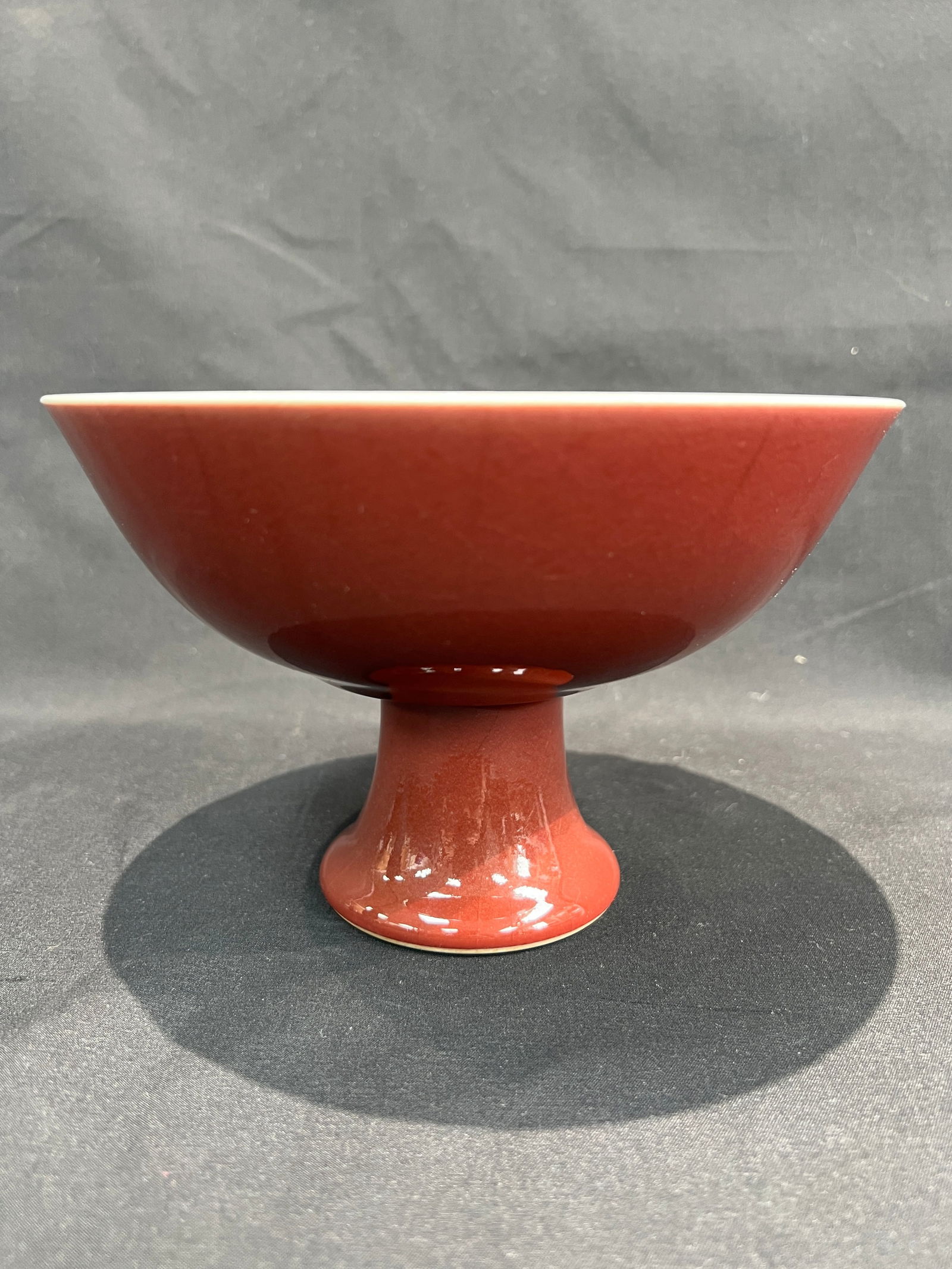 Qing Dynasty Sacrificial Red Glaze Stem Bowl with Yongzheng Mark: H11.5CM W17.7CM. Sacrificial red-glazed stem bowl marked 'Made in the Yongzheng Reign of the Great Qing.' White porcelain body with sacrificial red glaze. Dating assessment: Yongzheng mark of Qing Dyn