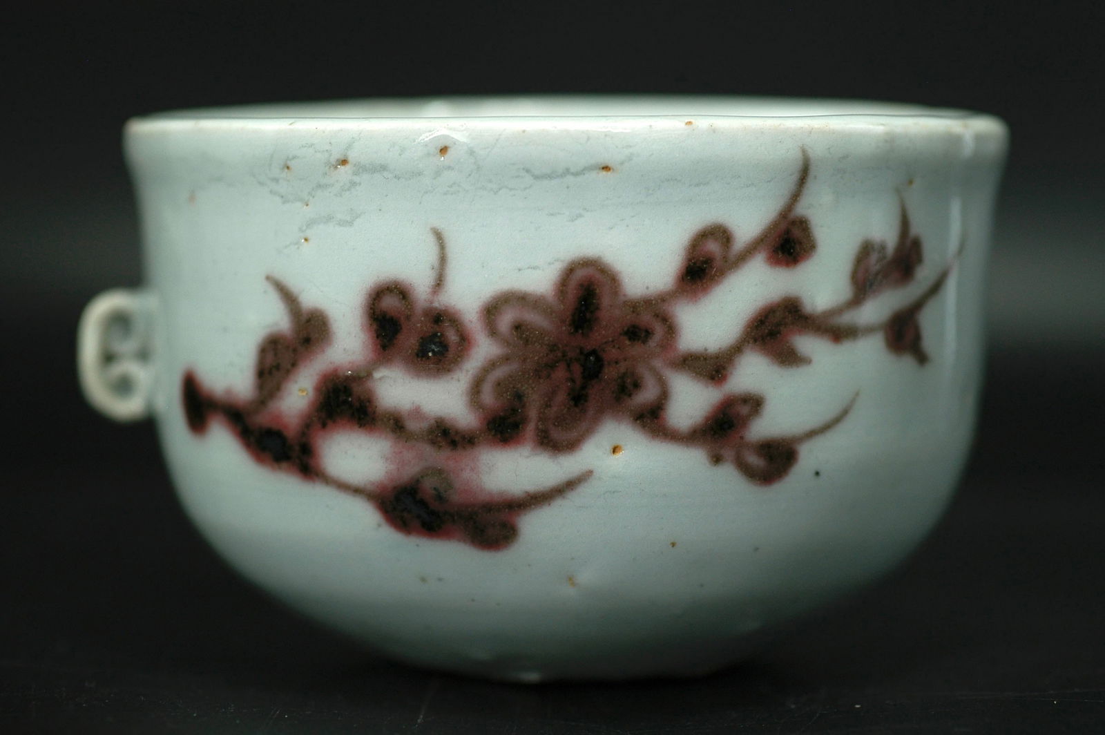 Yuan Dynasty Underglaze Red Prunus Ruyi-Handle Cup: H5cm M8.2cm Yuan Dynasty underglaze red plum blossom pattern double-handled cup. This piece represents early underglaze red folk kiln production with rare surviving examples. Features straight mouth,