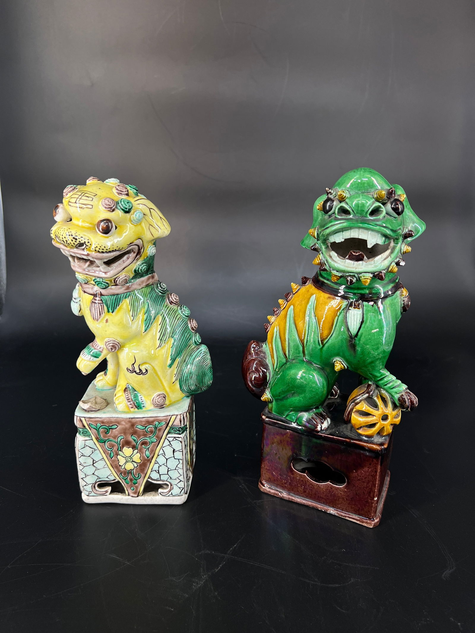 Late Qing to Republic Period Wucai Porcelain Lion, a Pair: H25cm W11cm (the yellow) H26.5cm W13cm (the green) Pair of wucai-glazed porcelain guardian lions, Late Qing to Republic period. Jingdezhen white porcelain body with low-temperature wucai (five-color)