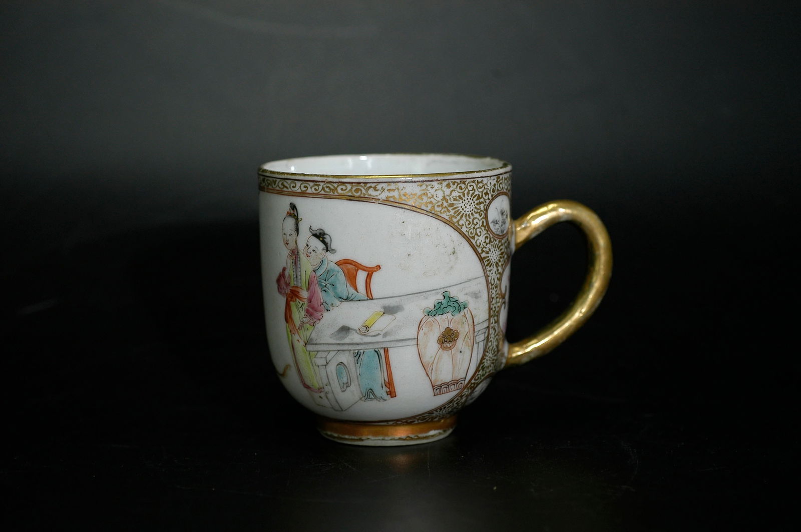 18th Century Canton Enamel Figural Handled Cup (Minor Chip Restored with Gold): H:6.3cm W:5.9cm Canton famille-rose gilt-decorated handled cup with figural story cartouches, Late Qing dynasty. White porcelain body with Canton enamel decoration and gilt highlights, Late Qing dynas