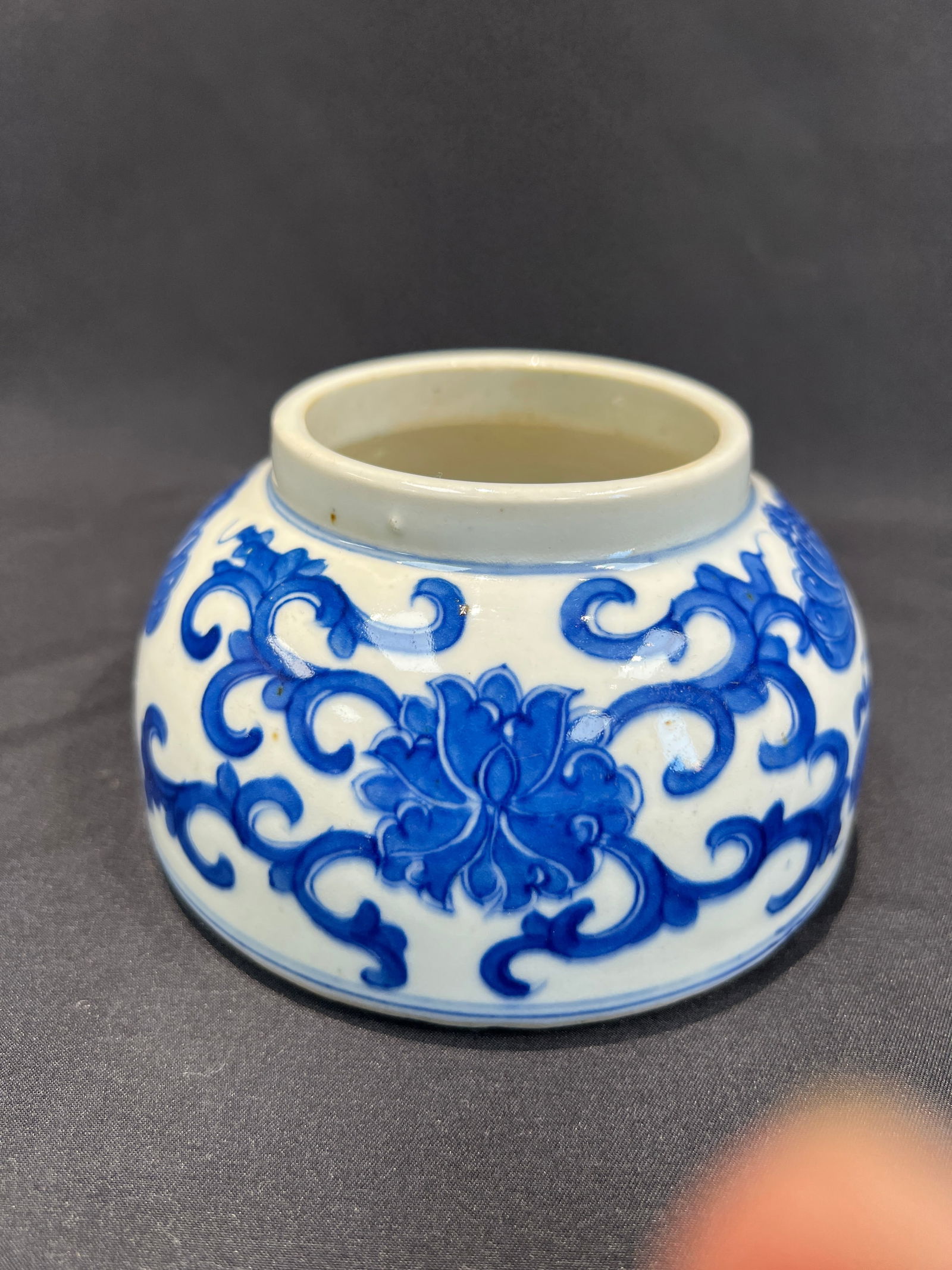 Blue and White Scrolling Lotus Butterfly Washer: H:7.2cm W:12.8cm Kangxi Period, Qing Dynasty Blue-and-White Horse-Hoof Shaped Water Vessel (Scholar's Water Pot). Essential Features: Form: Horse-hoof shape with gently turned inward rim, broad and le