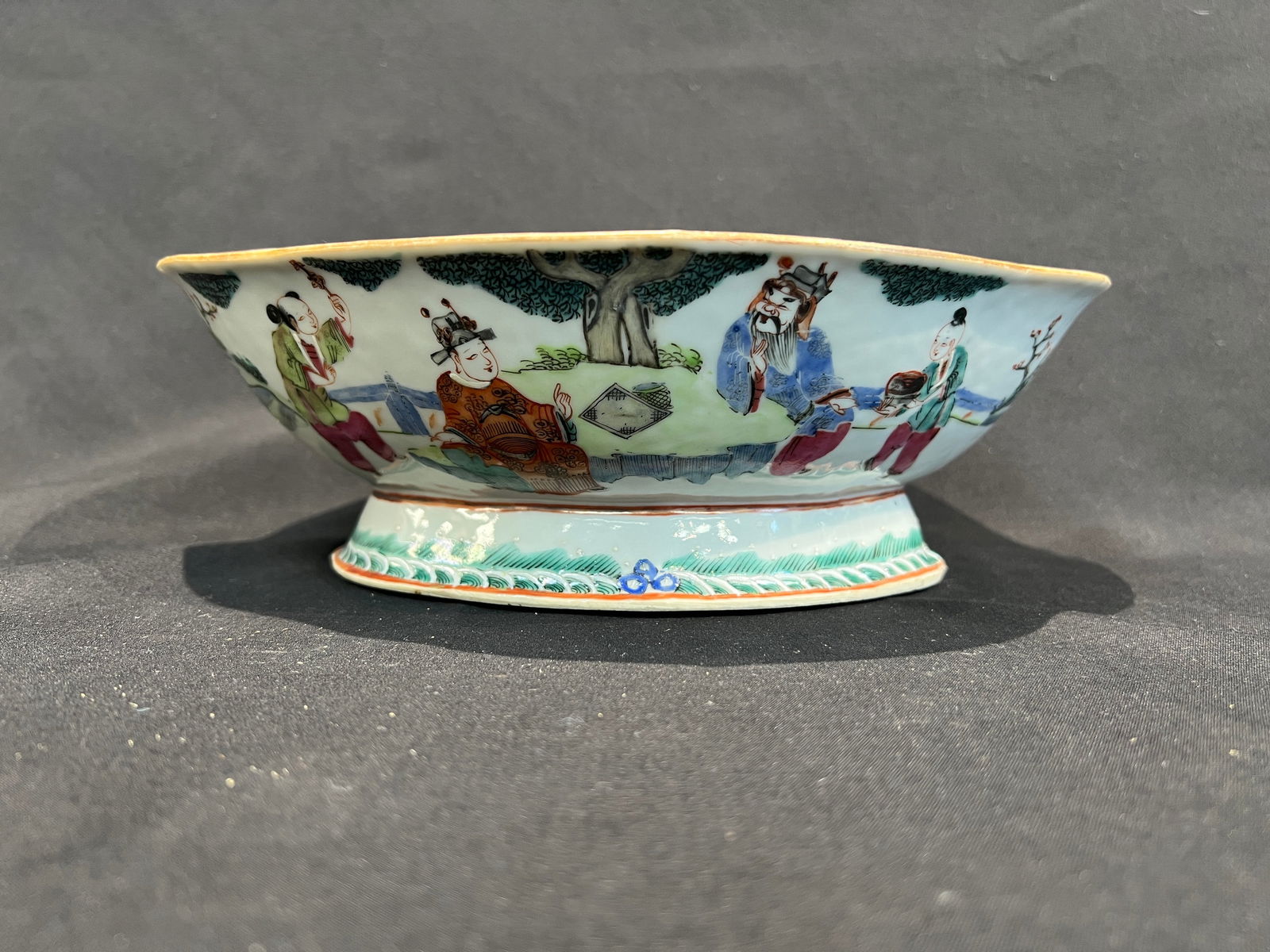 Qing Tongzhi Famille Rose Figural Narrative Begonia-Form Offering Bowl (Fu Lu Shou Three Stars: H8.1cm W25.7cm Qing Dynasty Tongzhi Period Famille-Rose Figural Narrative Begonia-Shaped Offering Bowl ("Fu Lu Shou Three Star Deities" Theme). Form: Begonia-shaped (foliate rim), high foot, shallow b